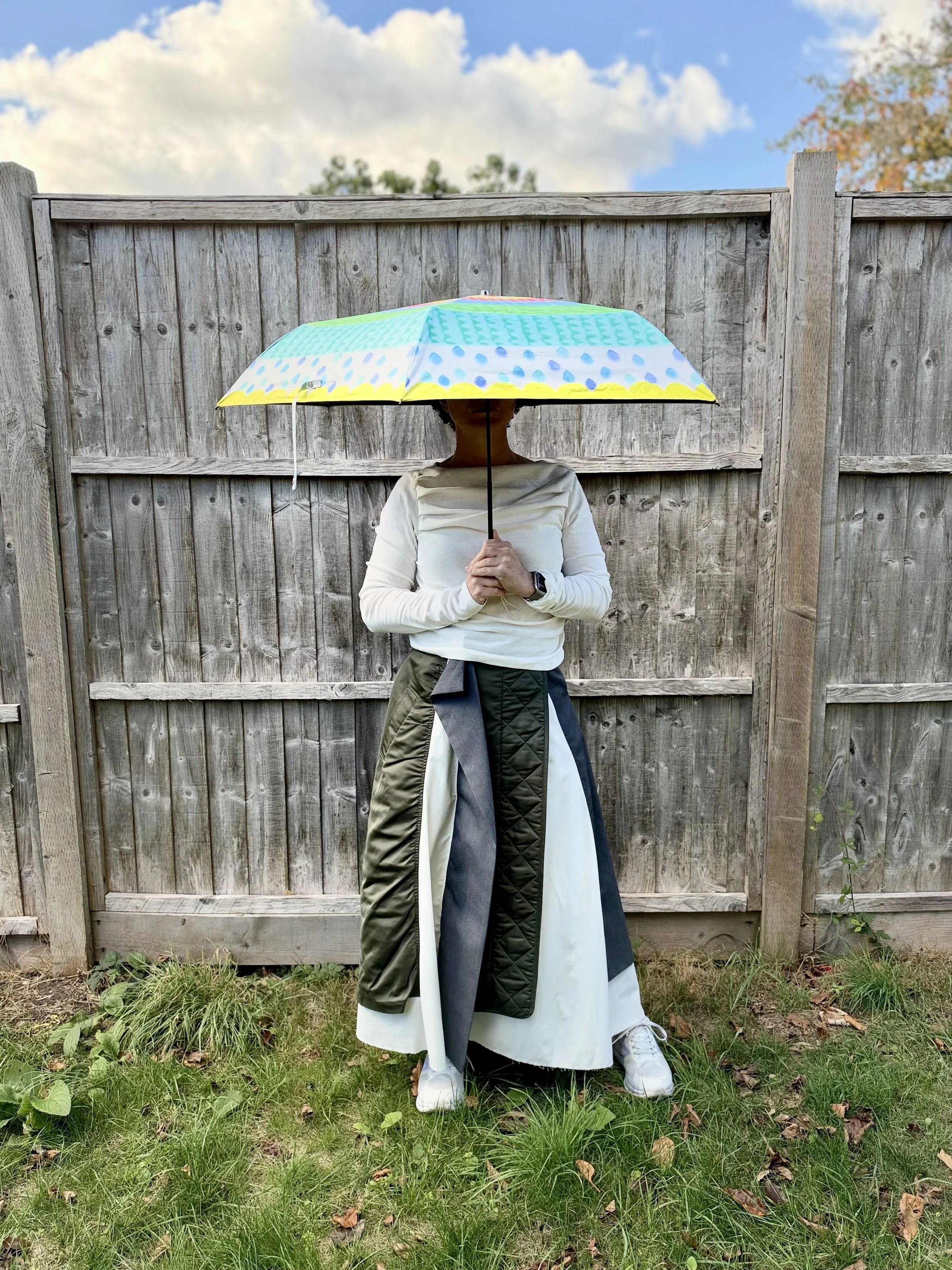 The author in an unusual Japanese skirt, face hidden by a colourful umbrella