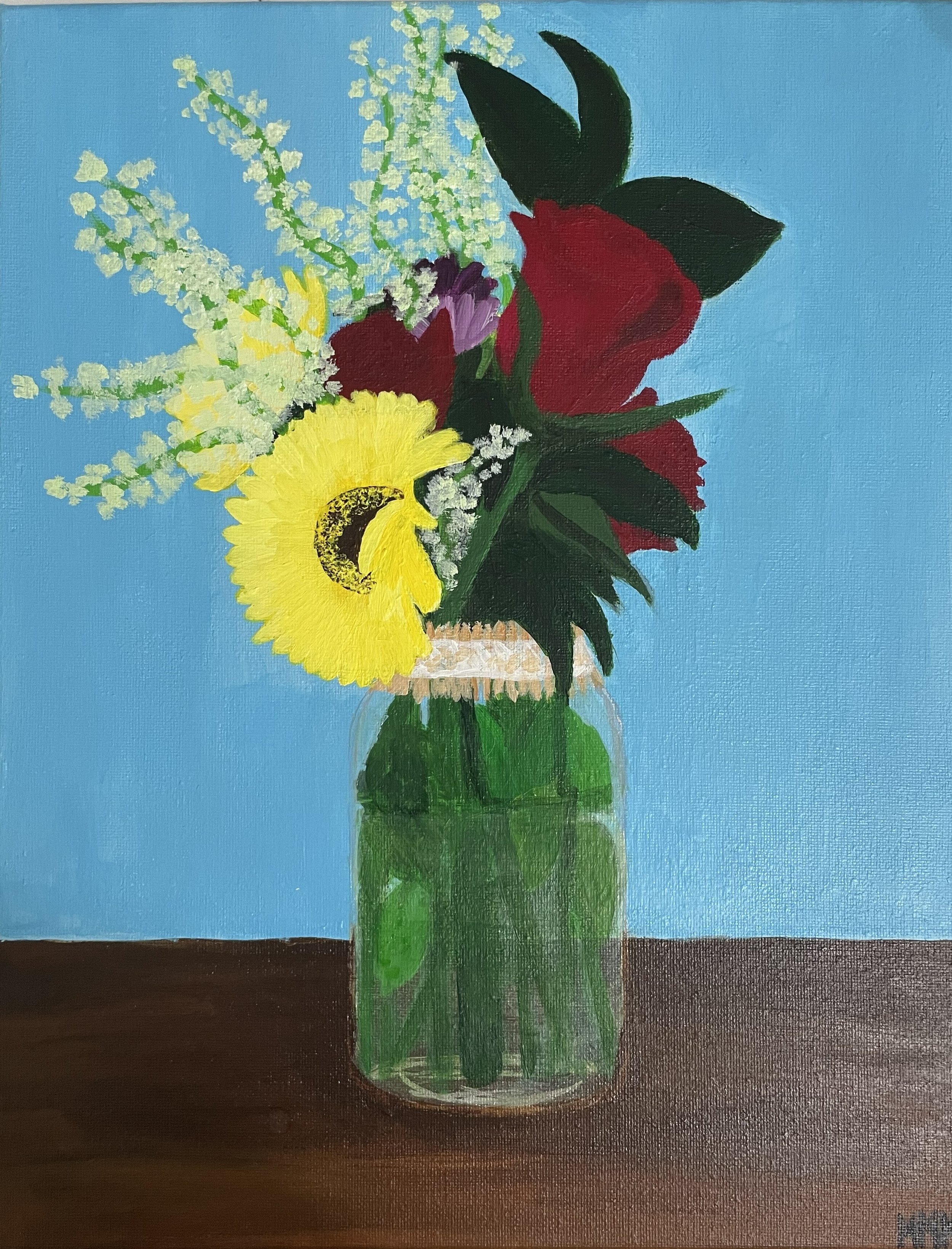 A still life painting of a bouquet of flowers in a clear glass jar, placed on a dark wooden surface against a blue background. The bouquet includes red roses, a yellow flower, white blossoms, and green foliage.
