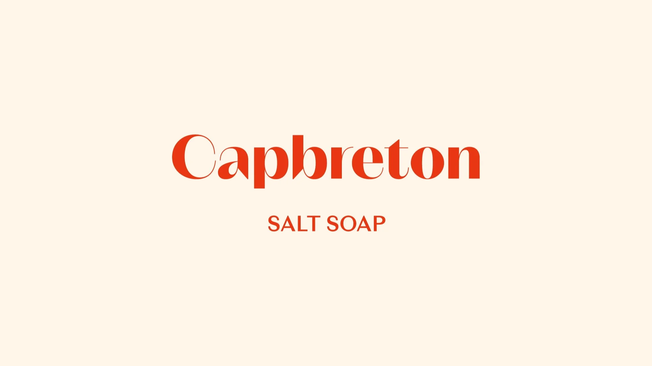 Texto "Capbreton Salt Soap" en fondo beige con letras rojas. Branding por Agosto Creative Studio. Branding y diseño de identidad visual y logotipo de marca de skincare y jabones.