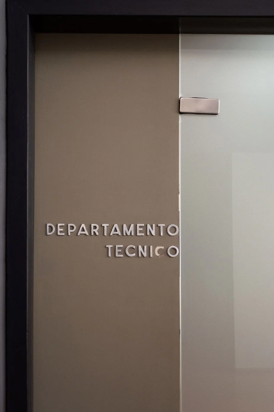 Puerta con la inscripción 'Departamento Técnico' en letras metálicas.