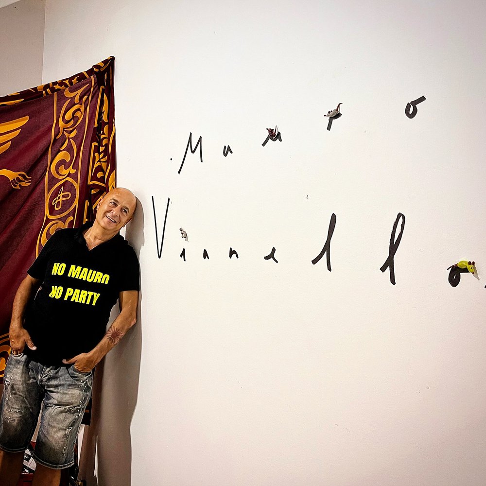 Mauro Vianello is looking at the installation on the wall