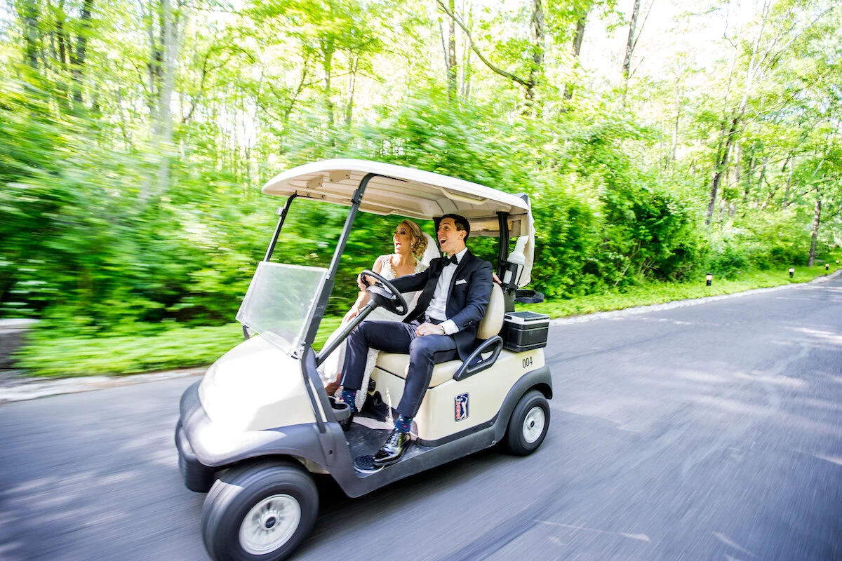 Bride and groom ride in golf cart