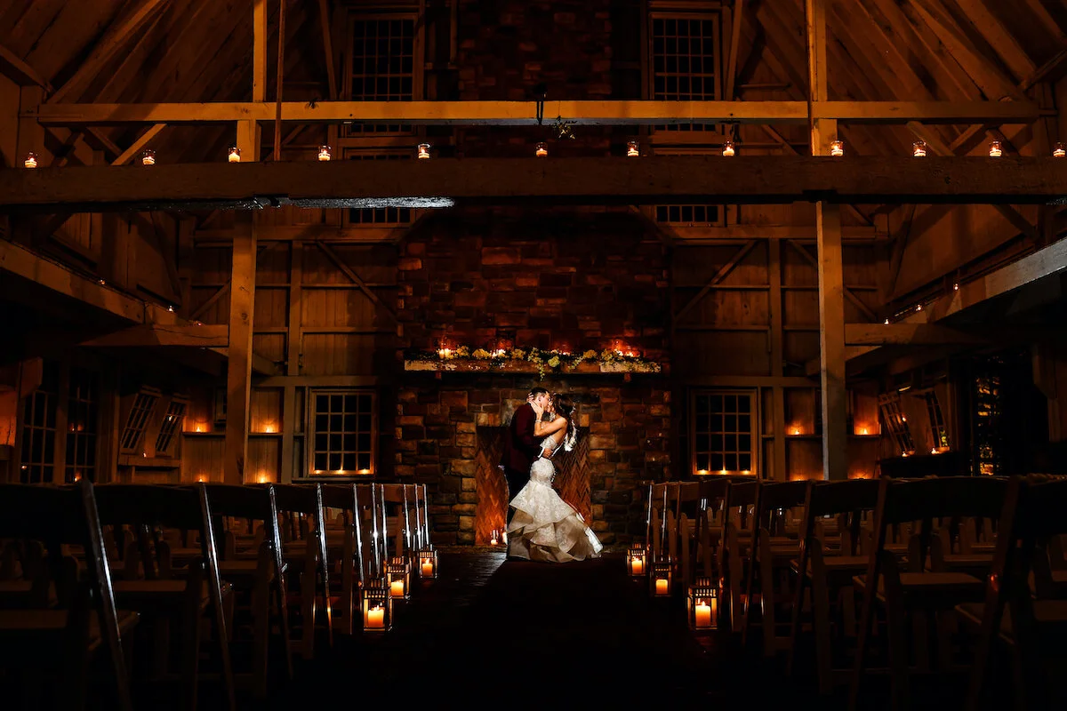 Bride and groom kiss alone in candlelit church
