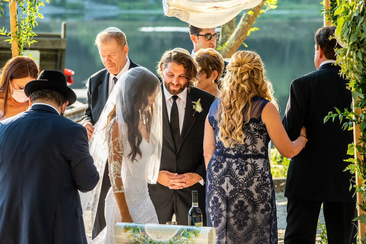 Bride and groom gather with friends at cocktail hour