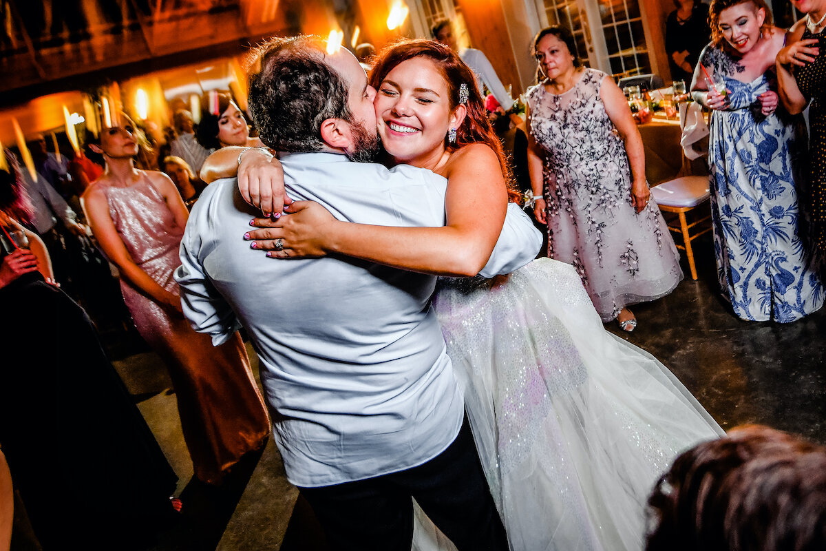 Bride and groom embrace on the dance floor