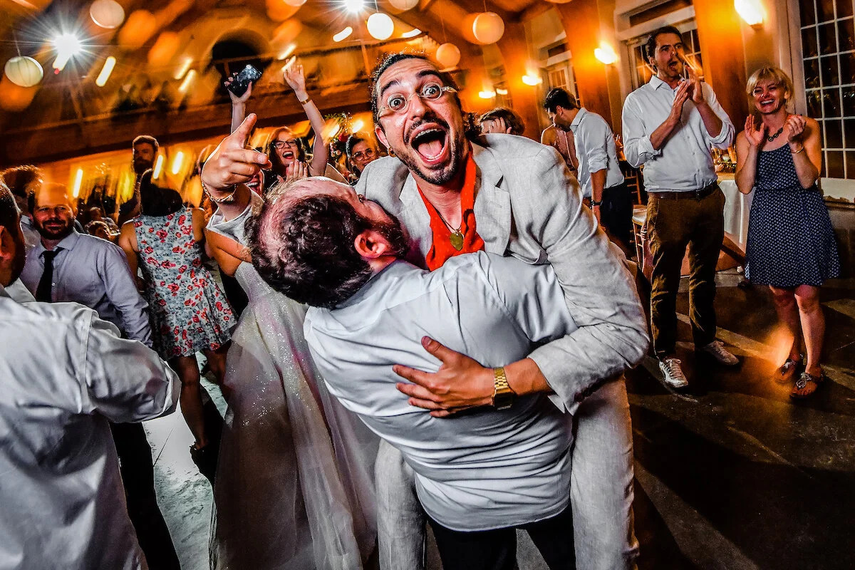 Guest jumps into groom's arms on dance floor