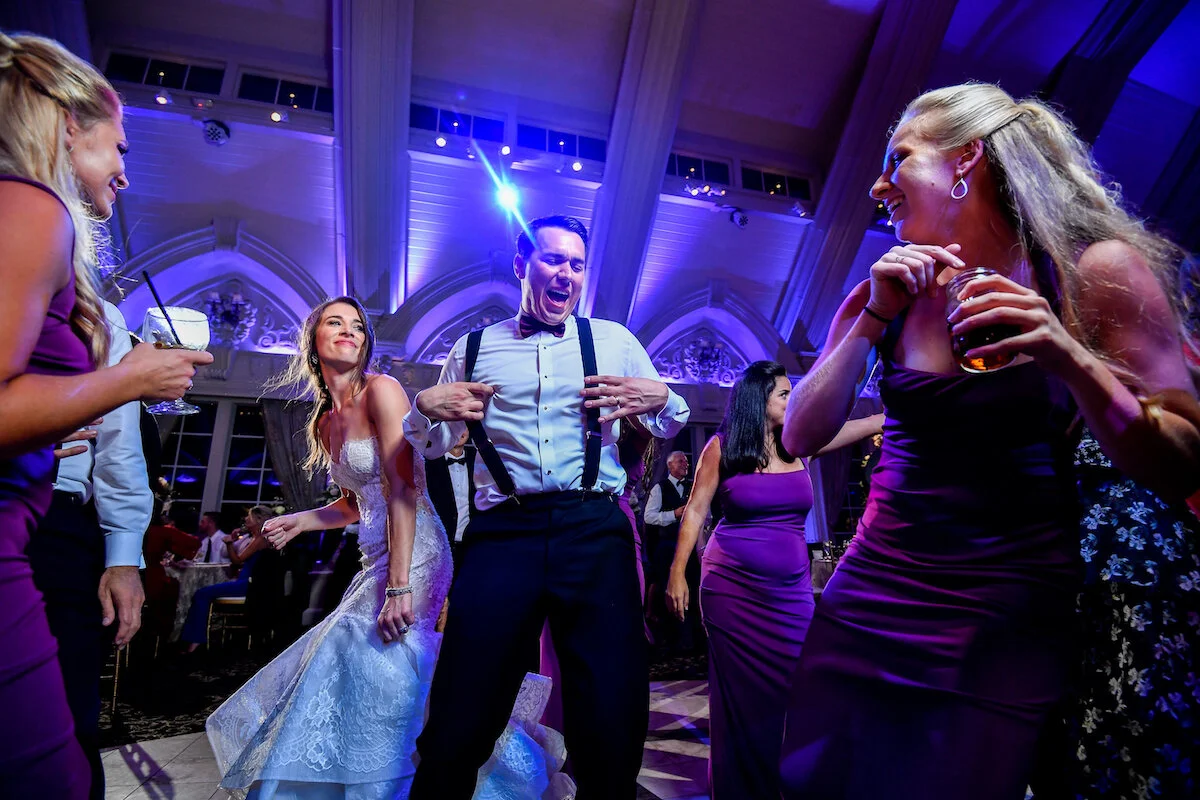 Bride, groom and bridal party dance on the dance floor