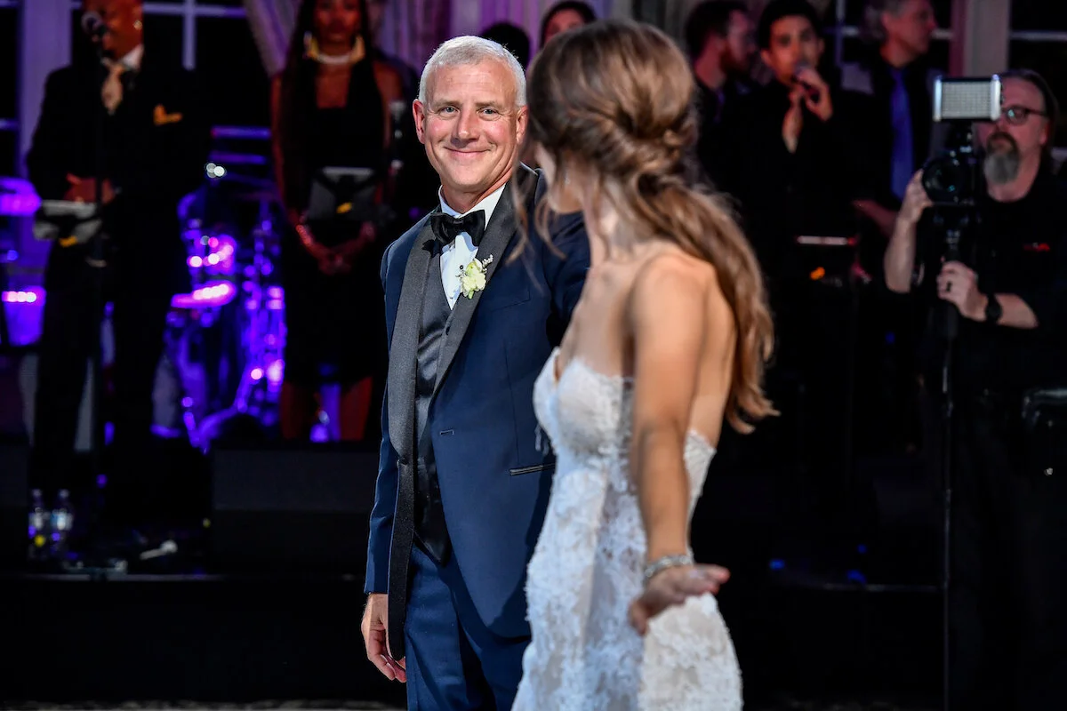 Father smiling during father and bride first dance