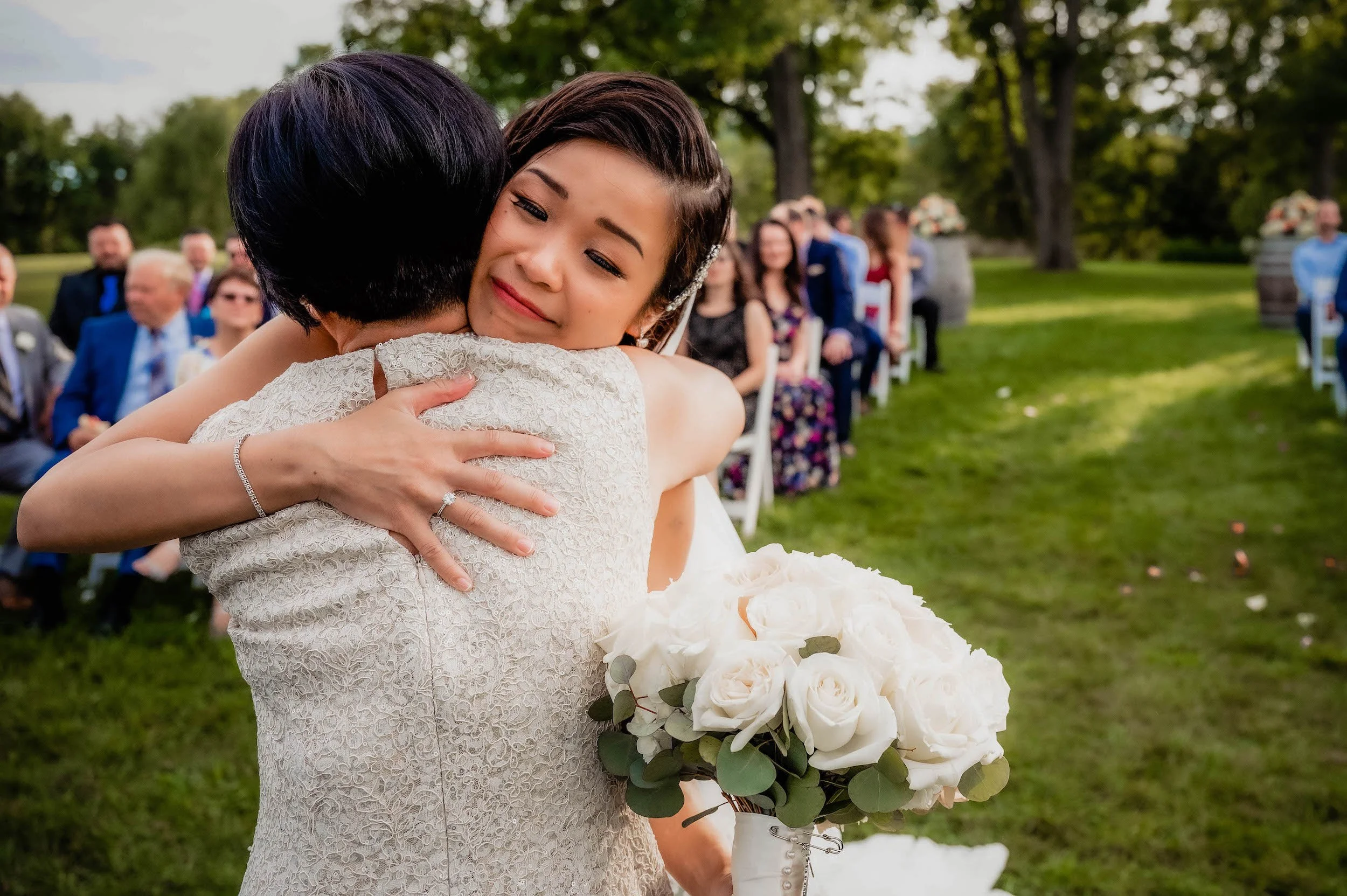 Mother of bride hugs bride