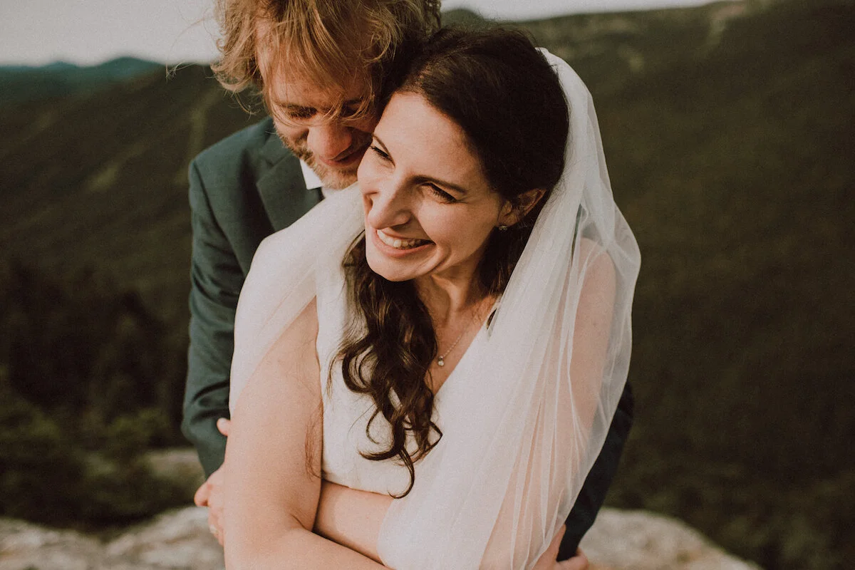 Closeup of groom and bride embracing