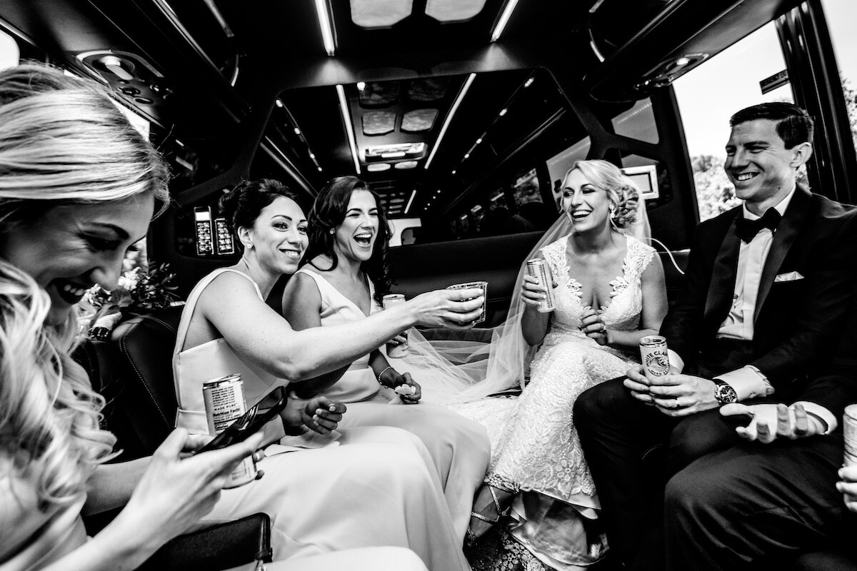 Bride and groom toast in limo