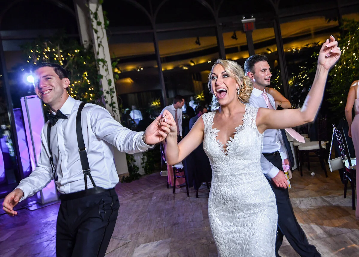 Bride and groom exit dance floor at end of reception