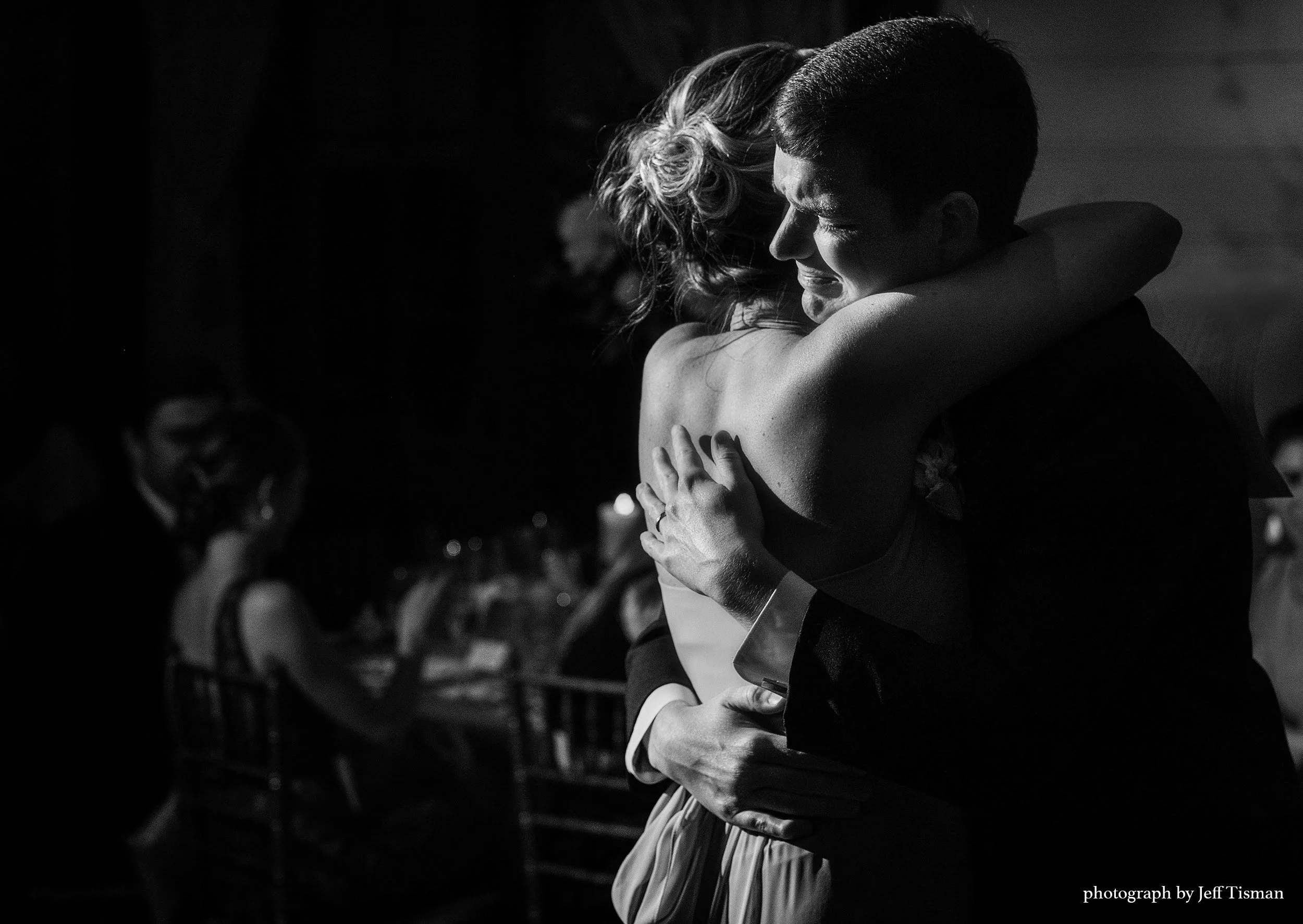 groom and his sister share an embrace and tears of joy wedding happiness