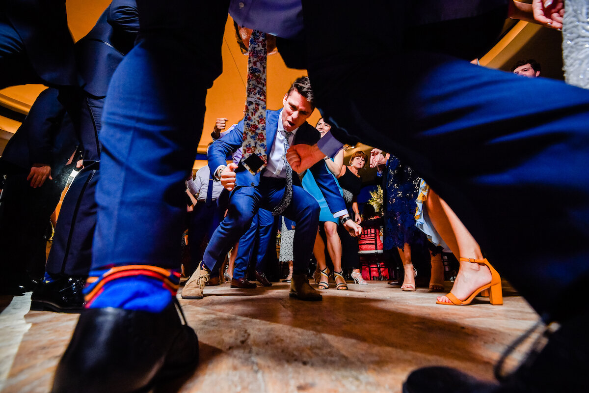 Groom plays air guitar on dance floor