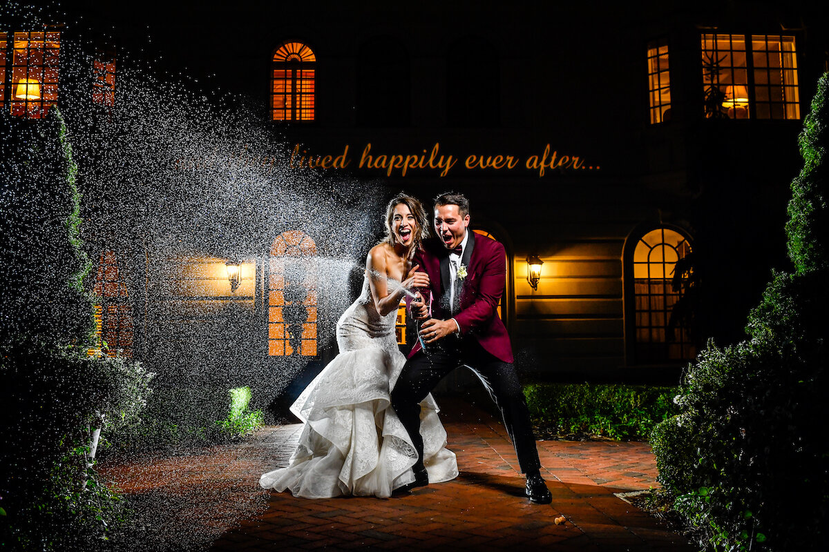 Bride and groom pop champagne bottle to end night