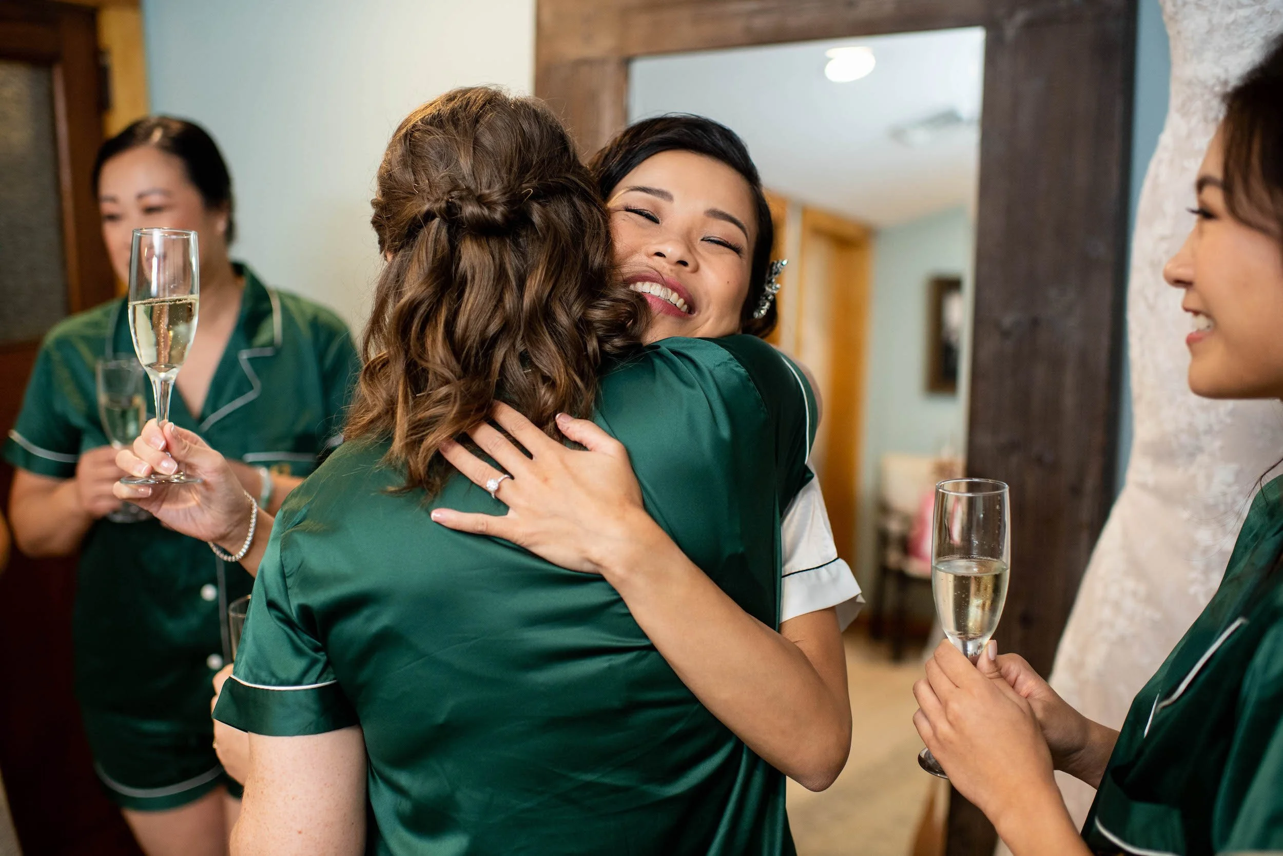 Bride and bridesmaid embrace
