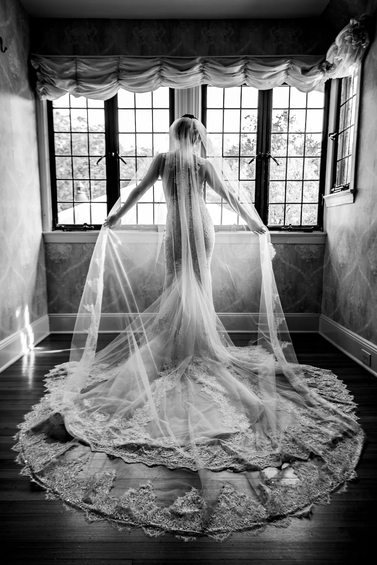 Back of bride in her wedding dress in bridal suite