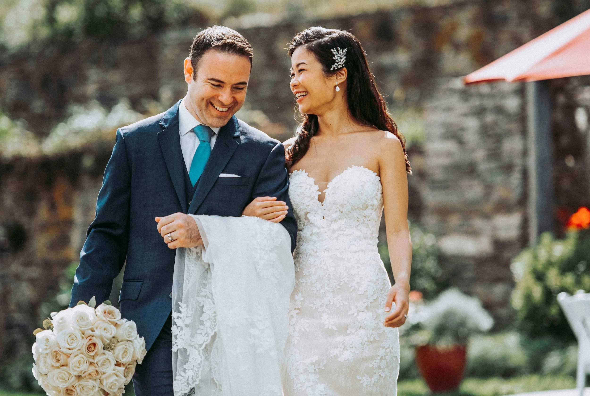 Bride and groom walk together down ceremony aisle