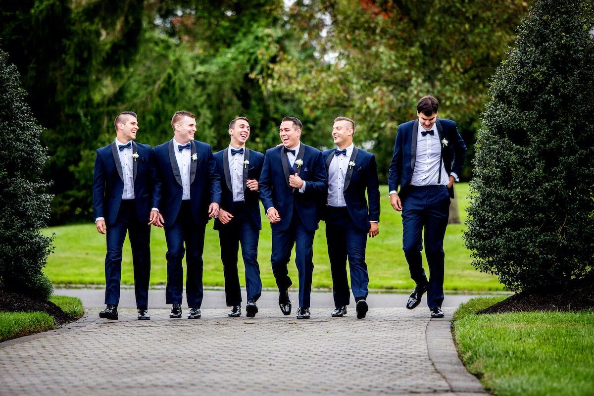 Groomsmen walking together on Ashford Estate grounds