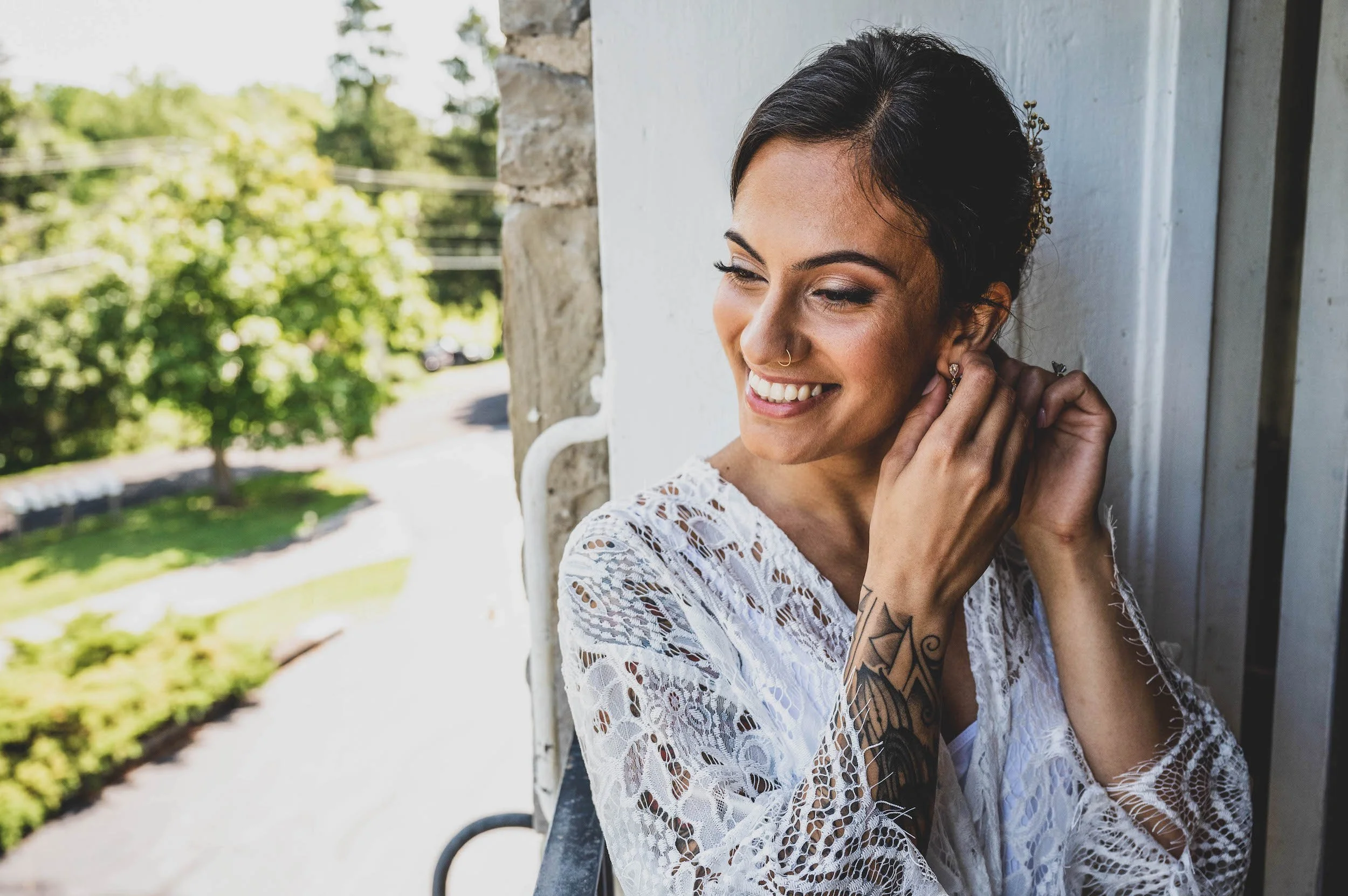Bride getting ready applying jewelry