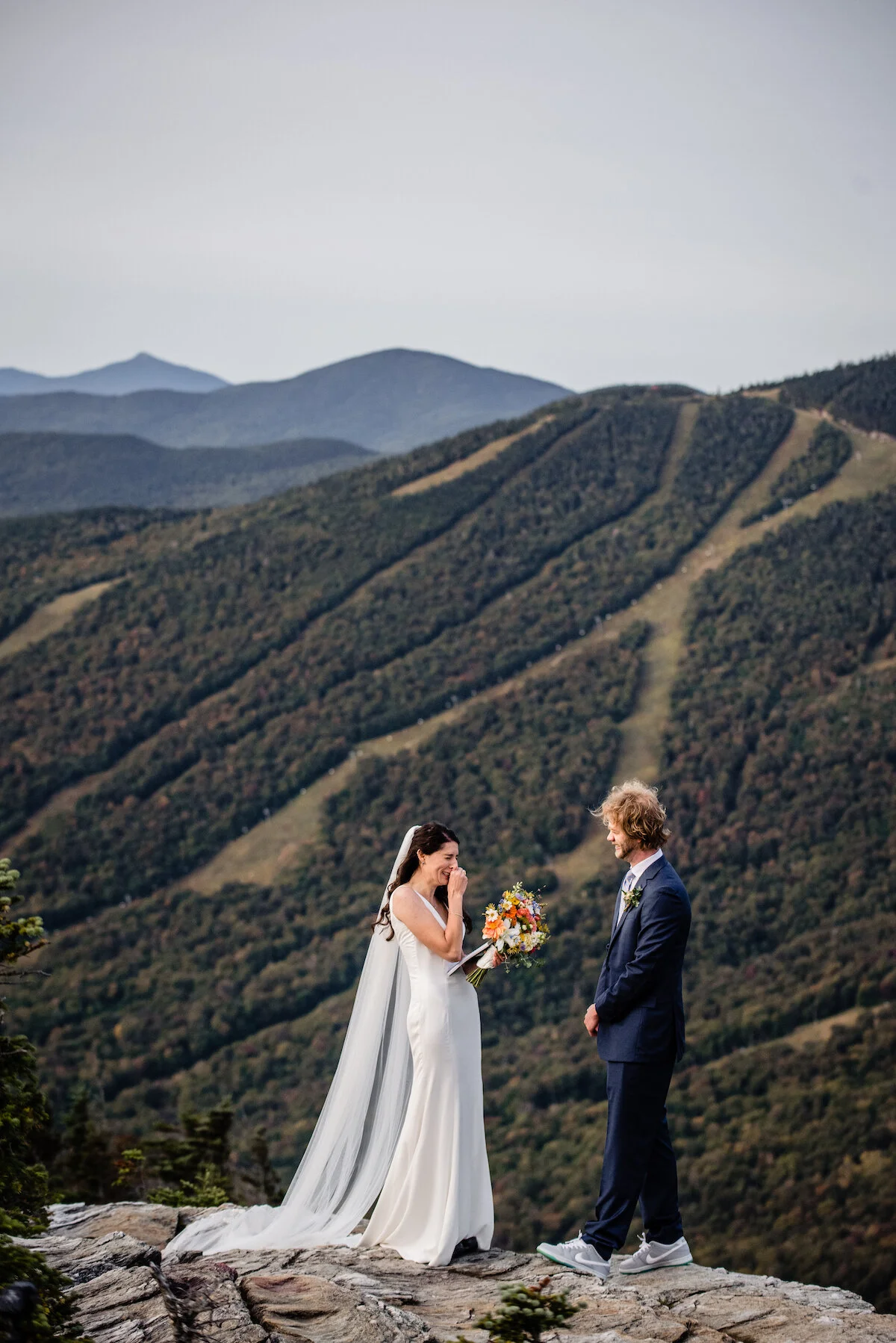 Bride tears up while sharing vows with Vermont mountains in background