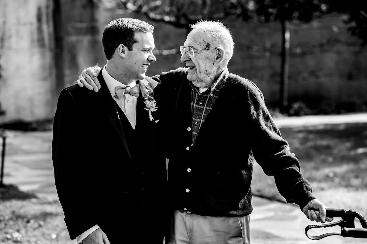 Groom and grandfather embrace
