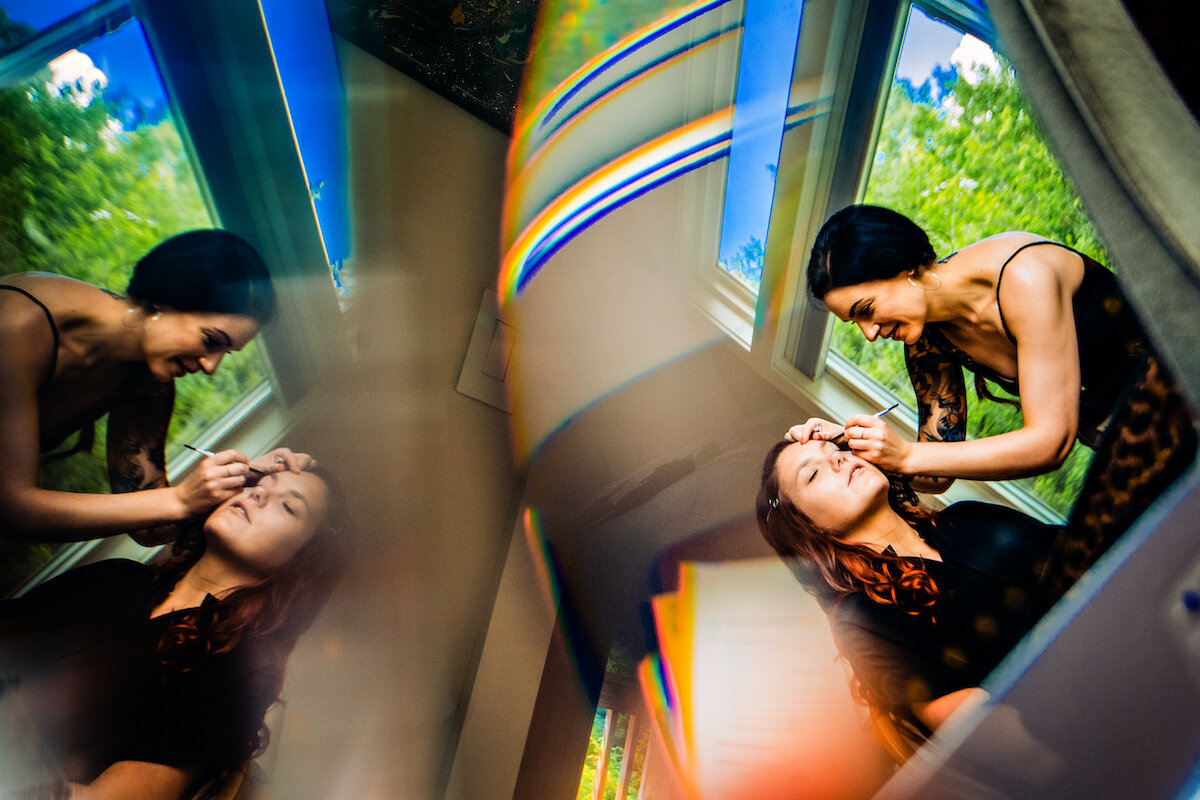 Makeup artist applies makeup on bride with mirror image effect
