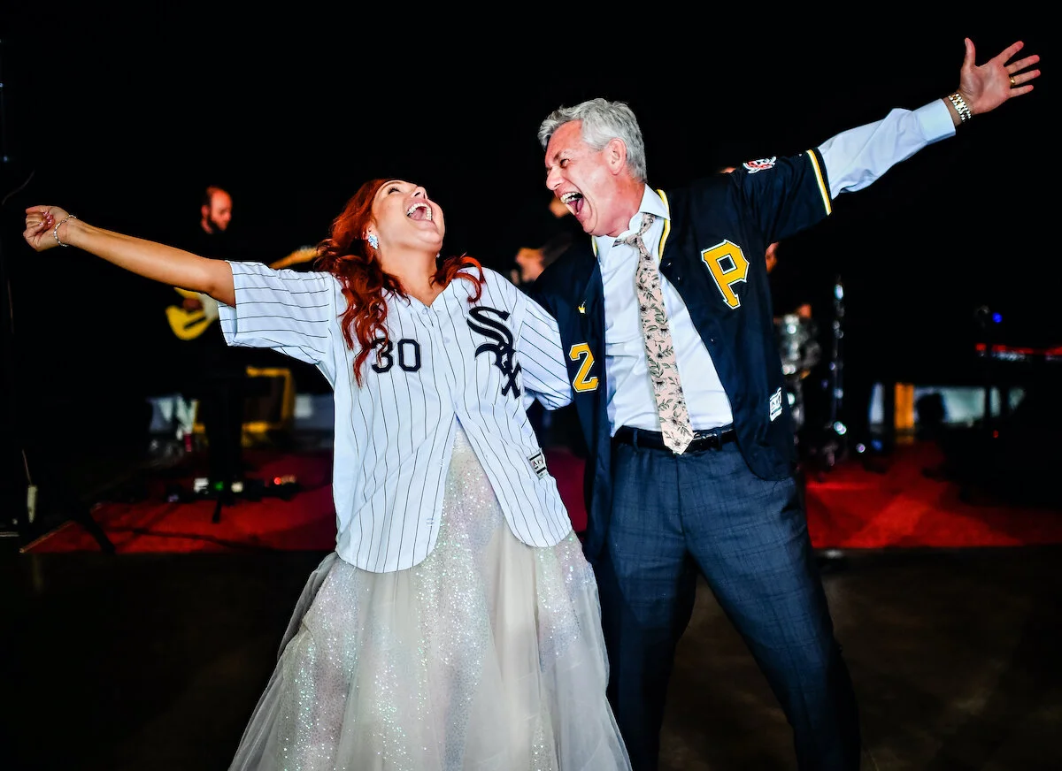 Bride and father of the bride share first dance in baseball team jerseys