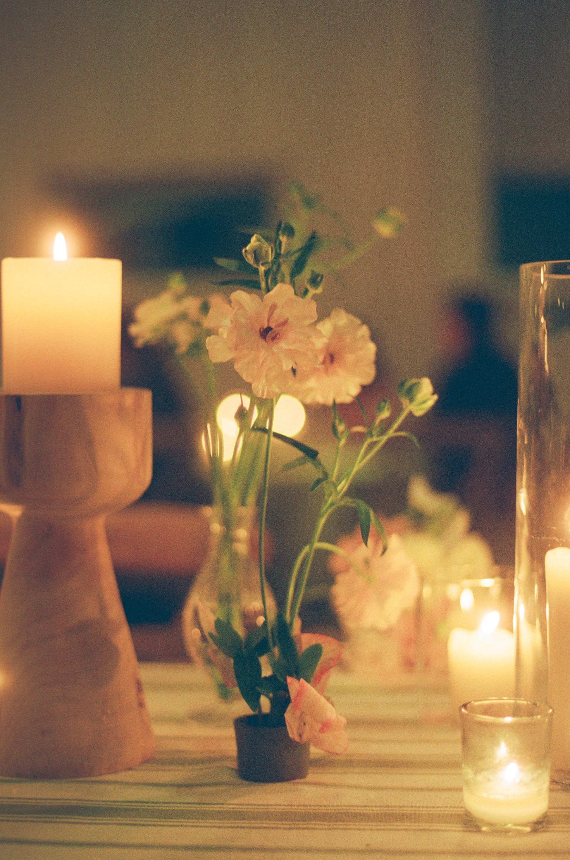 Low light photo of a flower arrangement at a dinner table at a wedding on 35mm film.