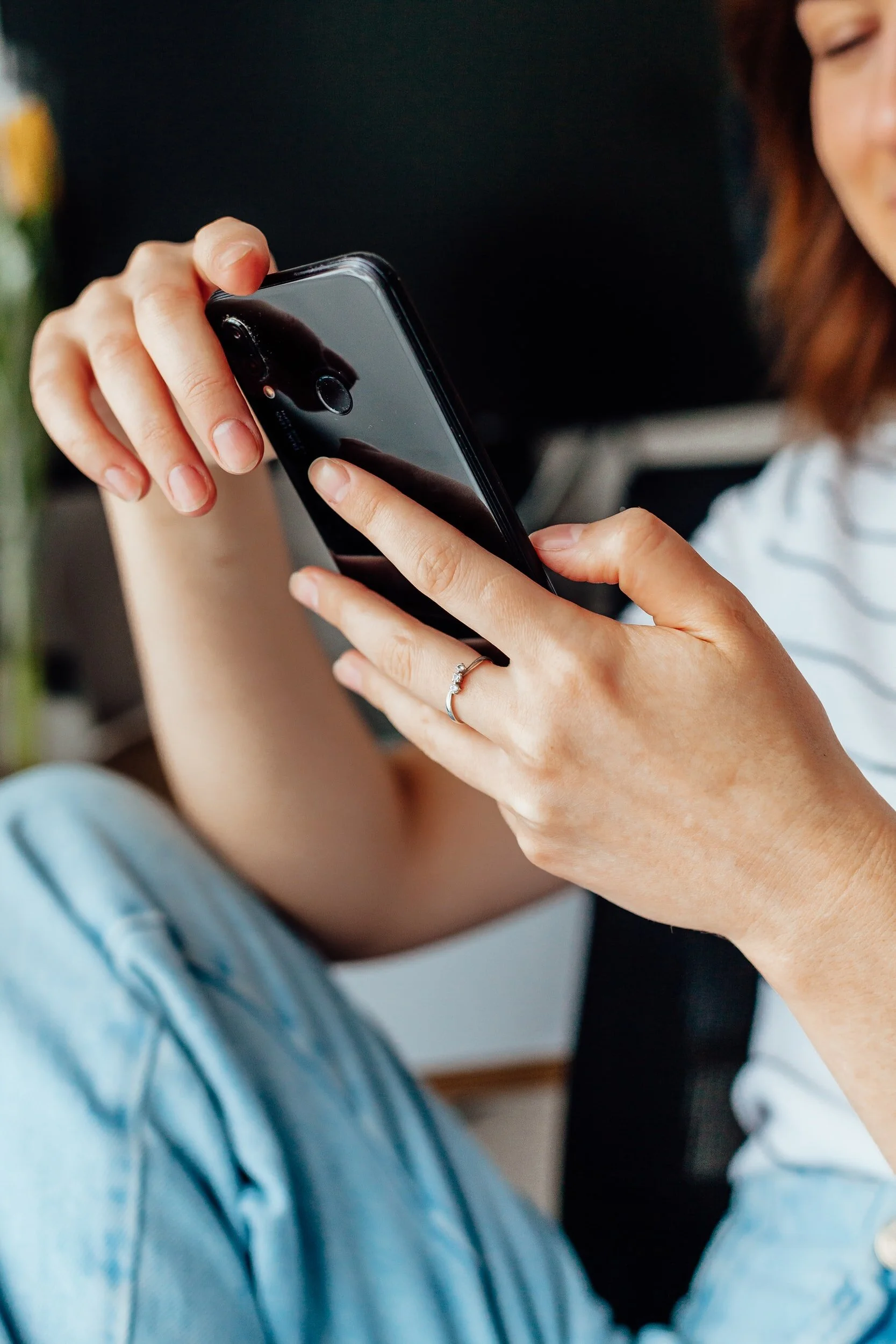 Woman texting on white phone