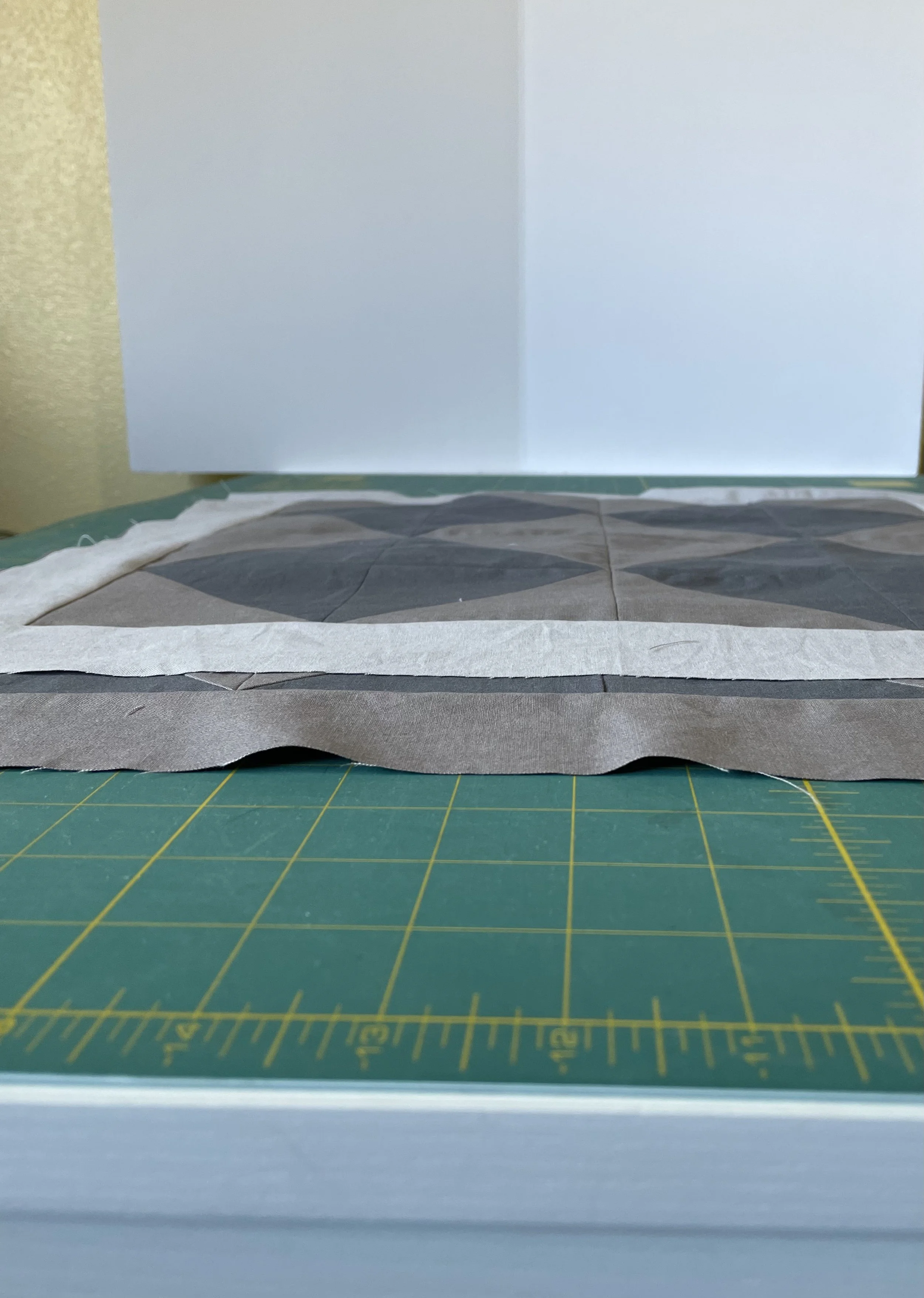 two methods of adding borders, showing that measuring first then sewing is more accurate