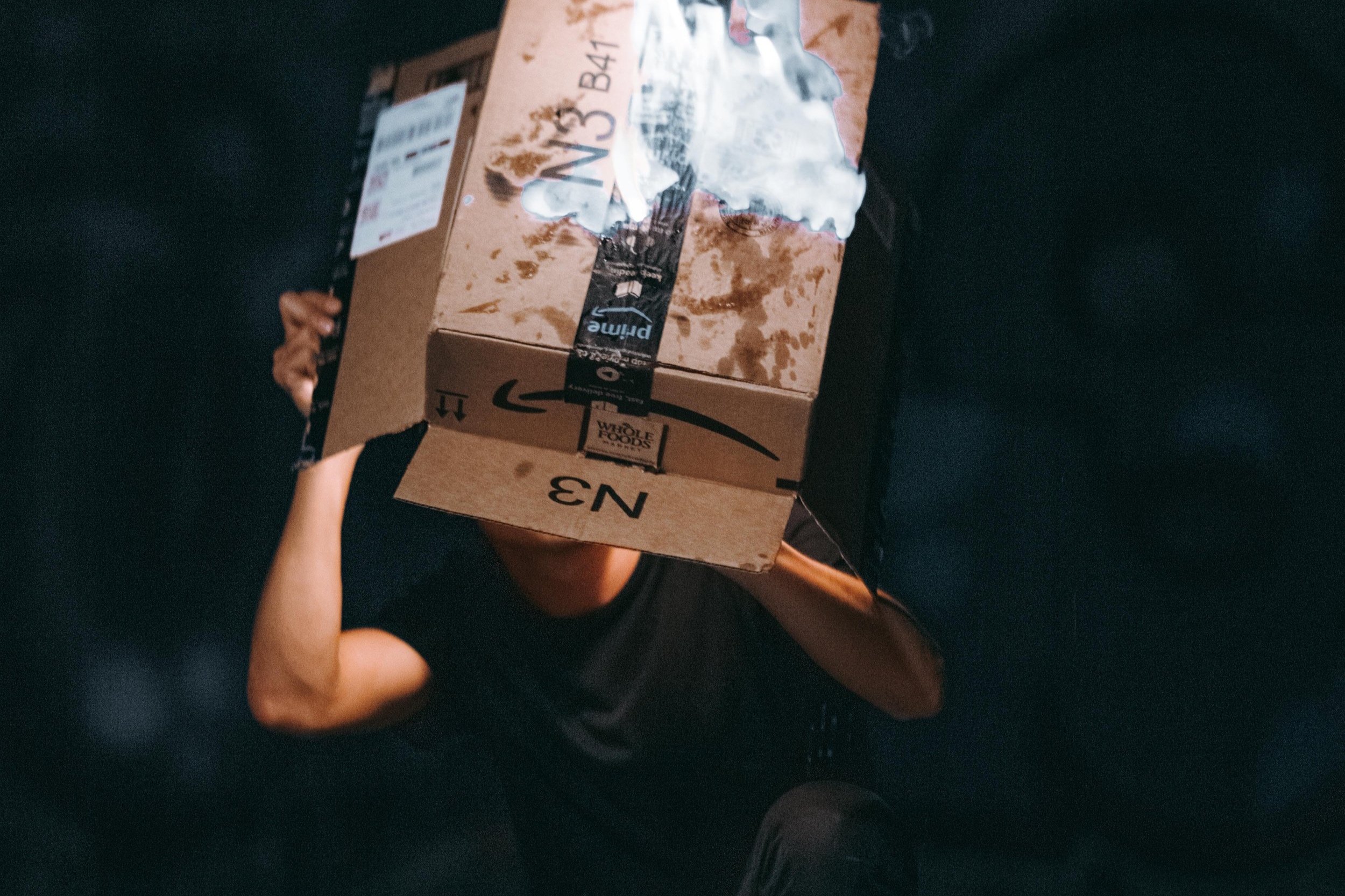 A person is burning an Amazon box.