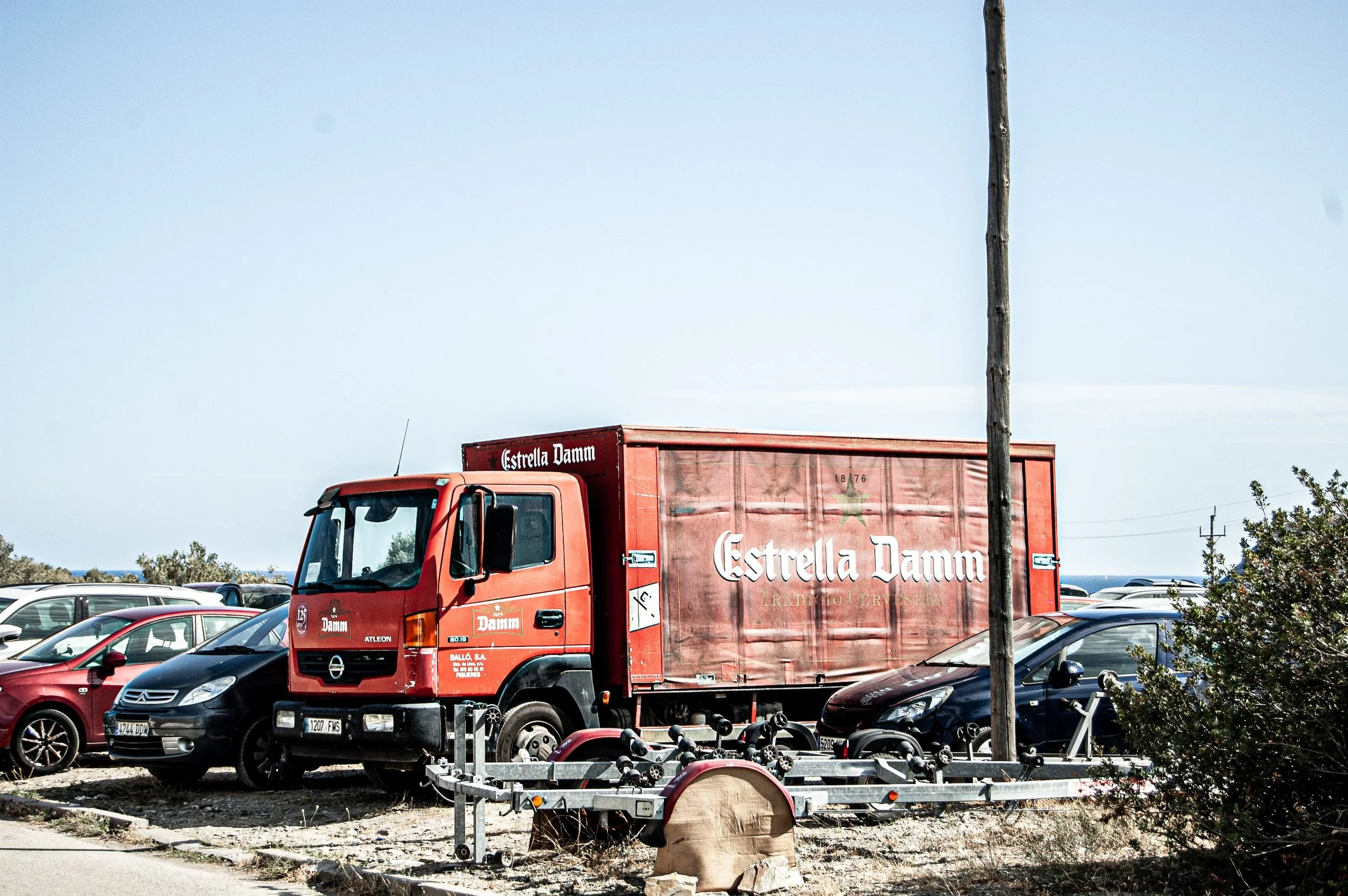 Estrella Damm semi truck parked in a parking lot.