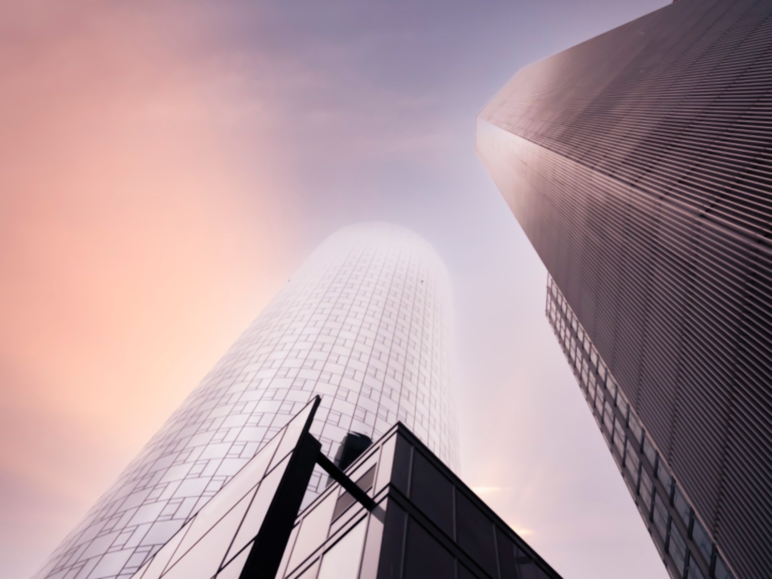 Skyscraper buildings next to each other in the sunset light.