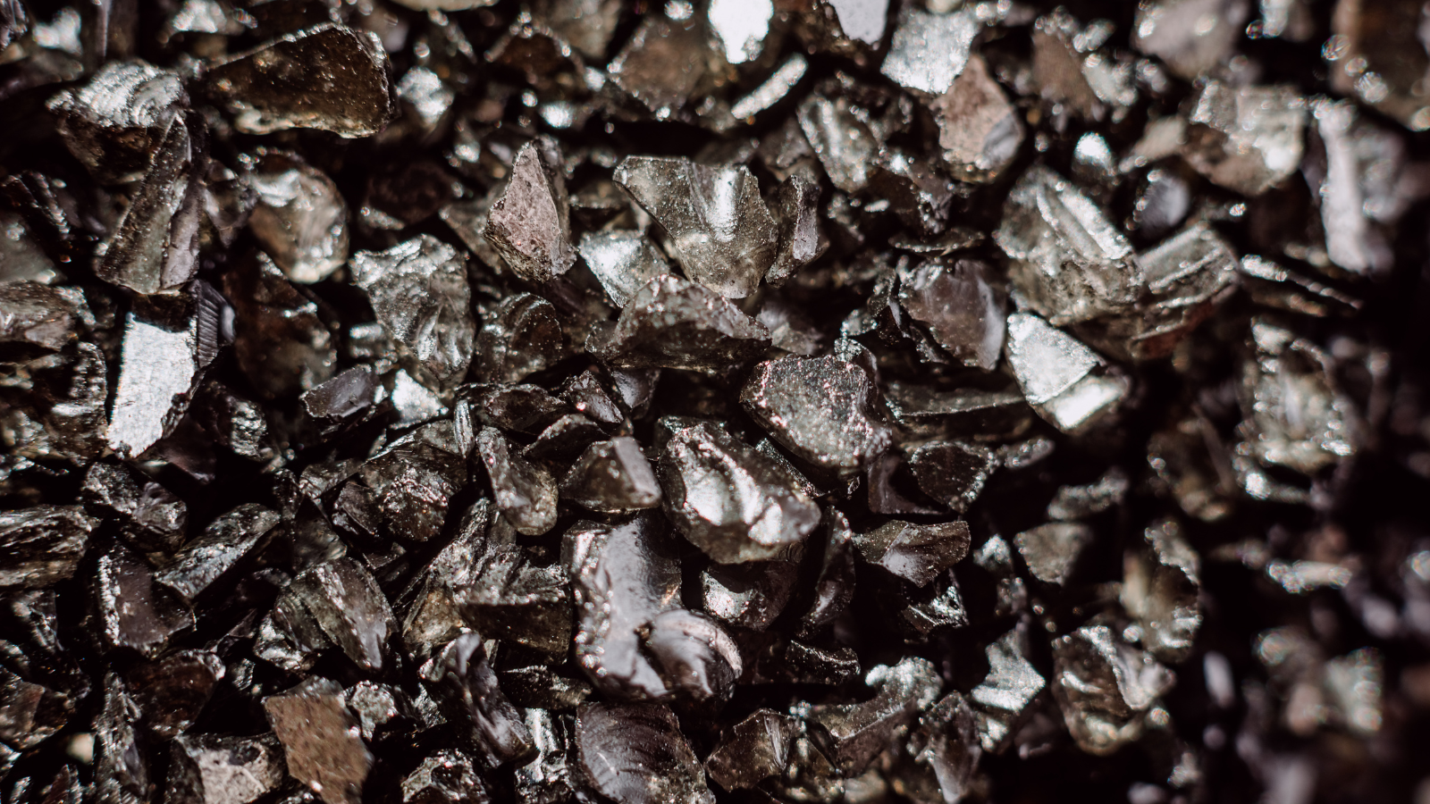 A pile of black pieces of rare earth minerals.
