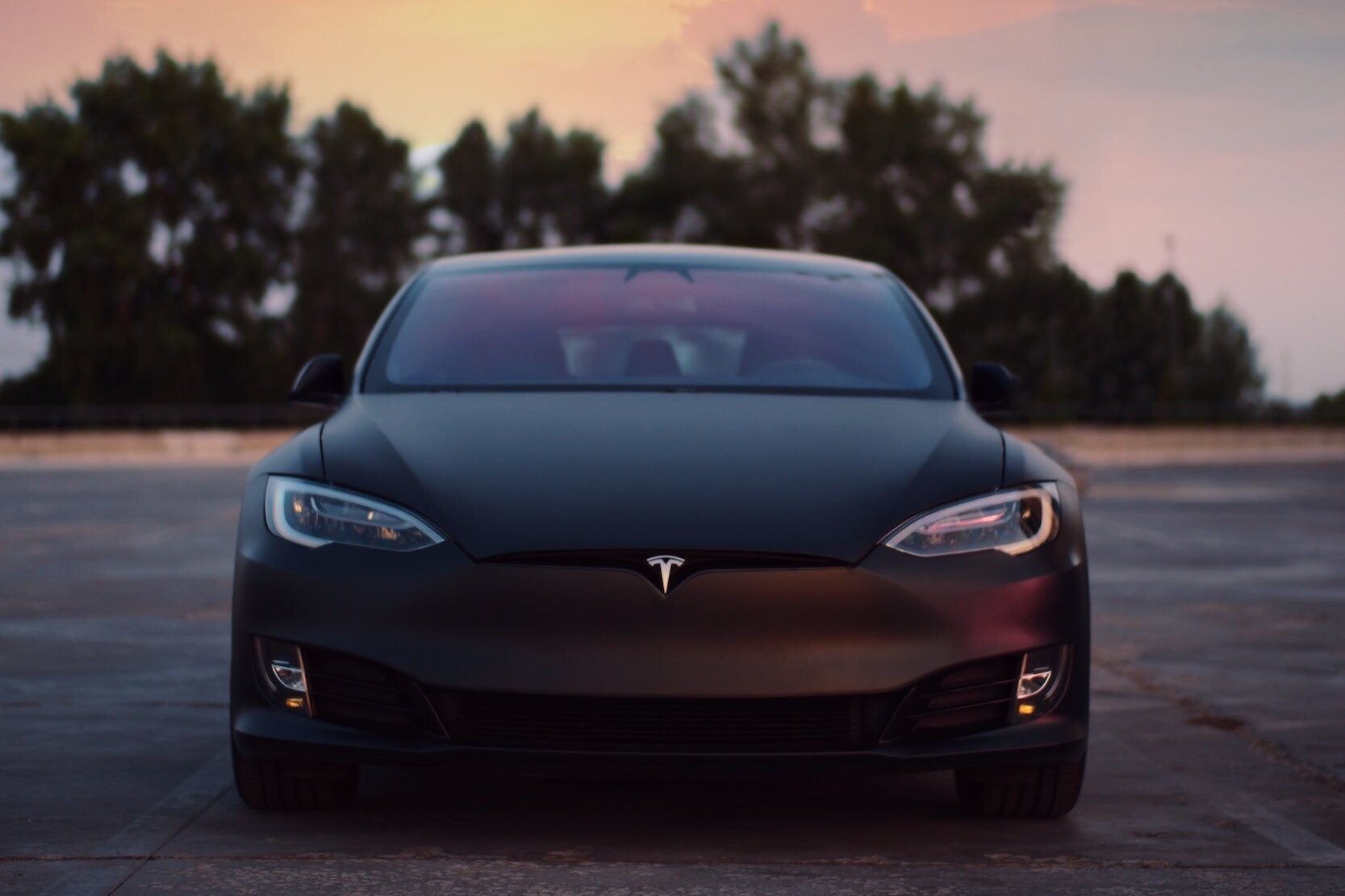 A Tesla model 3 in a parking lot.