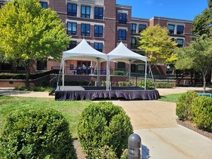 stage and tent installation at Elmhurst building by dupage tents and events