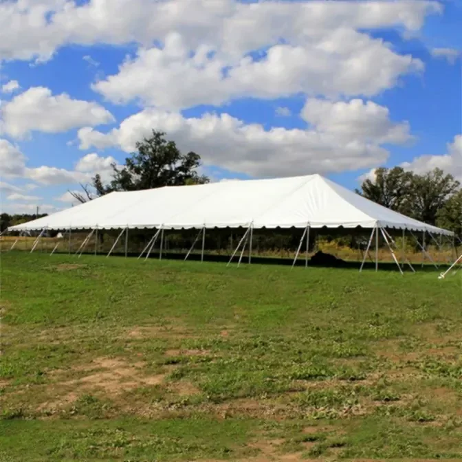 40x100 classic pole tent covering large outdoor wedding celebration
