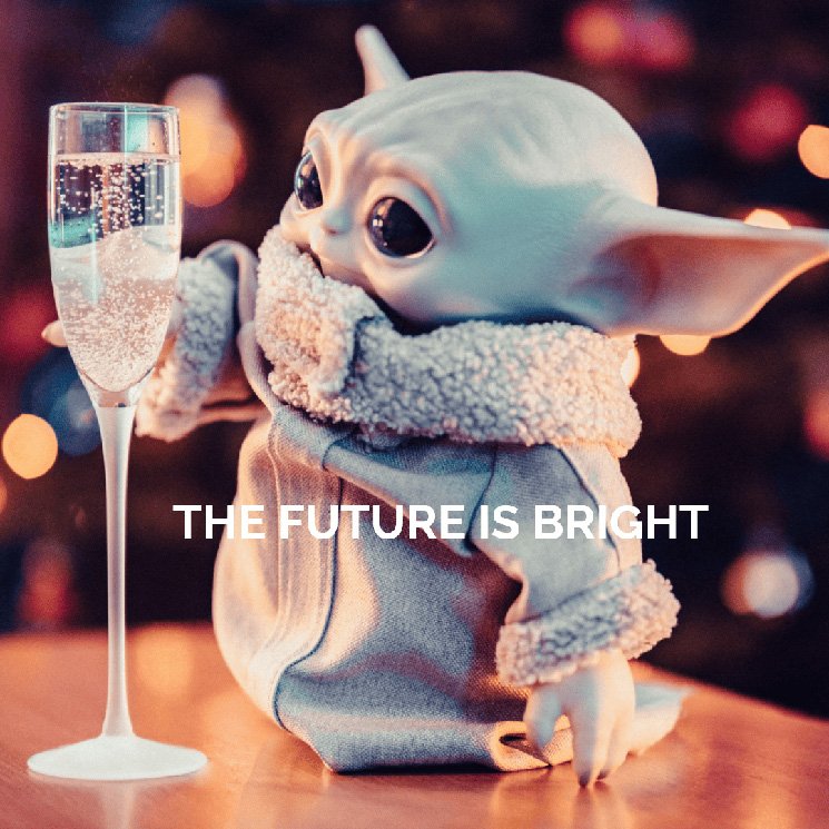 Yoda from 'Stars Wars' is holding a champagne glass, with sparkling lights in the background.