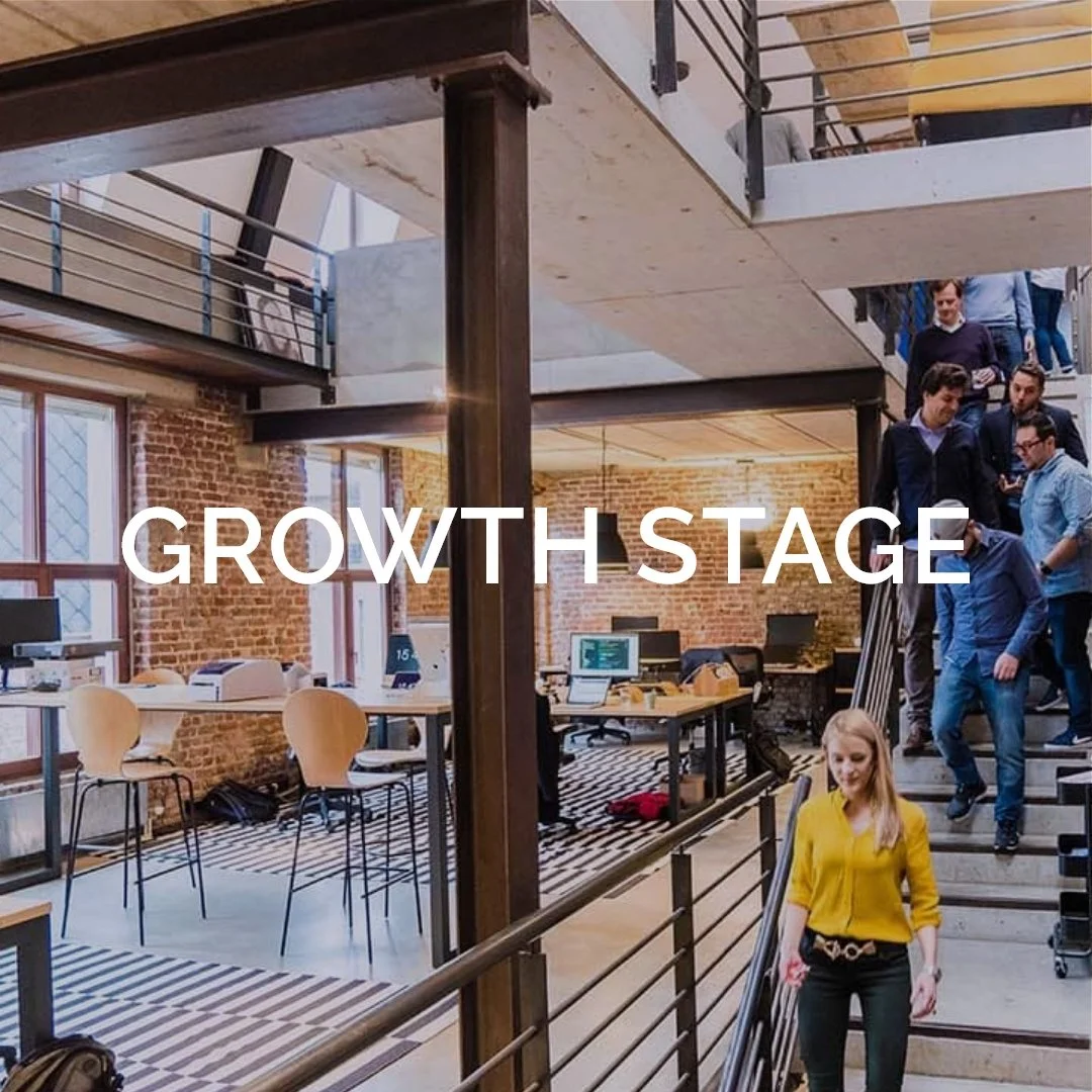 Startup team going down the stairs in a cool multi level office loft
