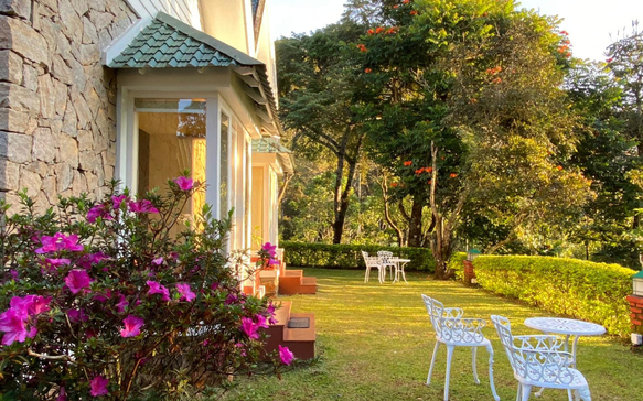 Charming Sri Lankan hill country cottage with blooming gardens, outdoor seating, and peaceful landscaped surroundings for restorative retreats.