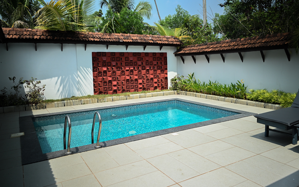 Private plunge pool at a Sri Lankan tropical wellness villa with sun loungers, peaceful garden walls, and secluded relaxation space.