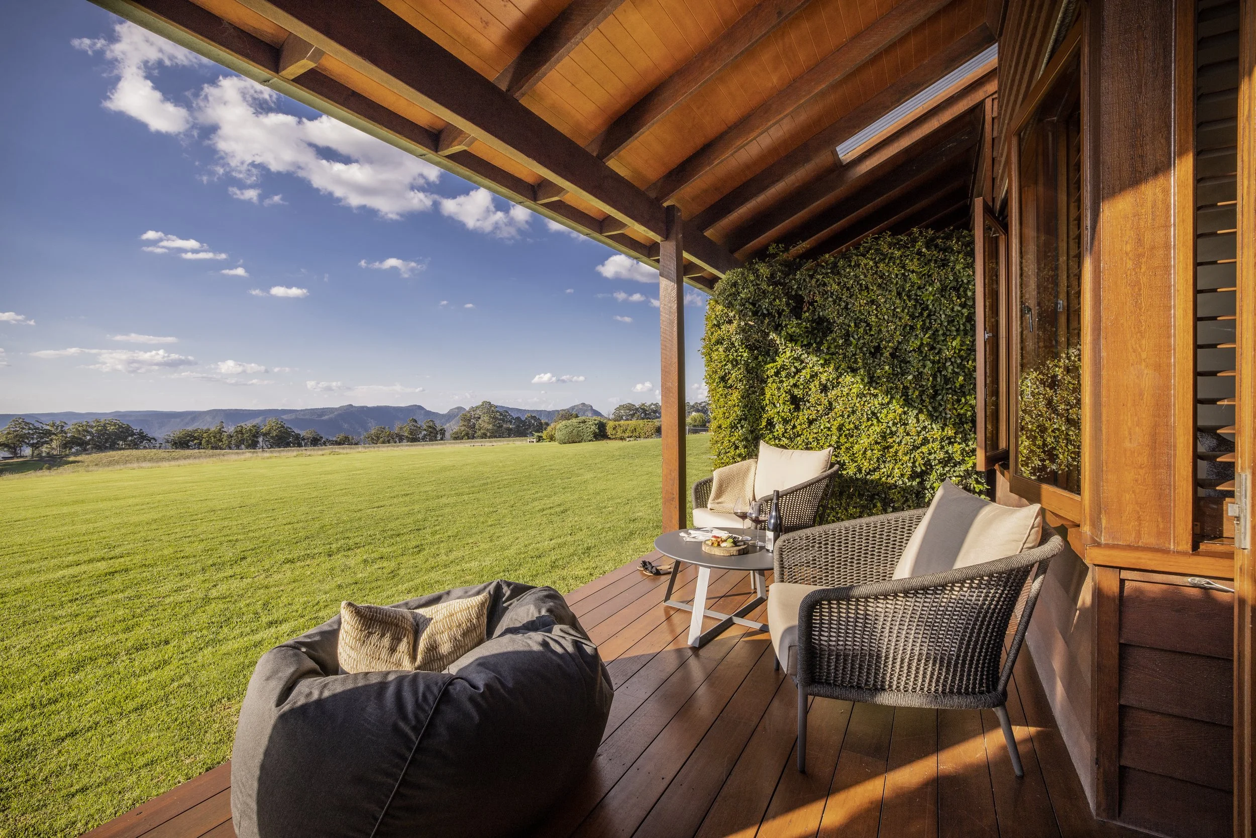 Private lodge terrace at Spicers Peak Lodge overlooking open countryside and mountain views in Queensland