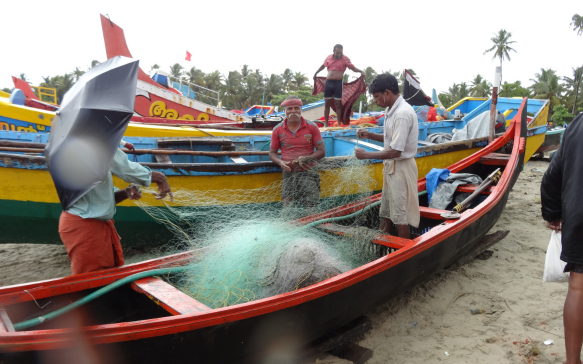 Sri Lankan fishermen preparing fishing nets beside vibrant traditional boats on a tropical beach, capturing authentic coastal life, maritime culture, and the hardworking spirit of local fishing communities.