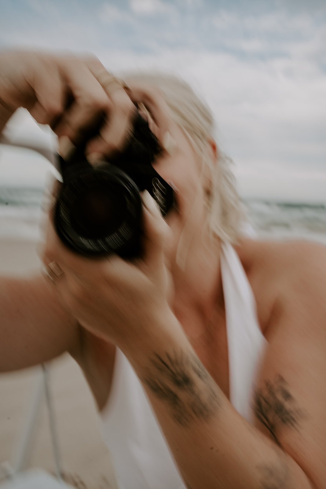 girl with camera on beach out of focus
