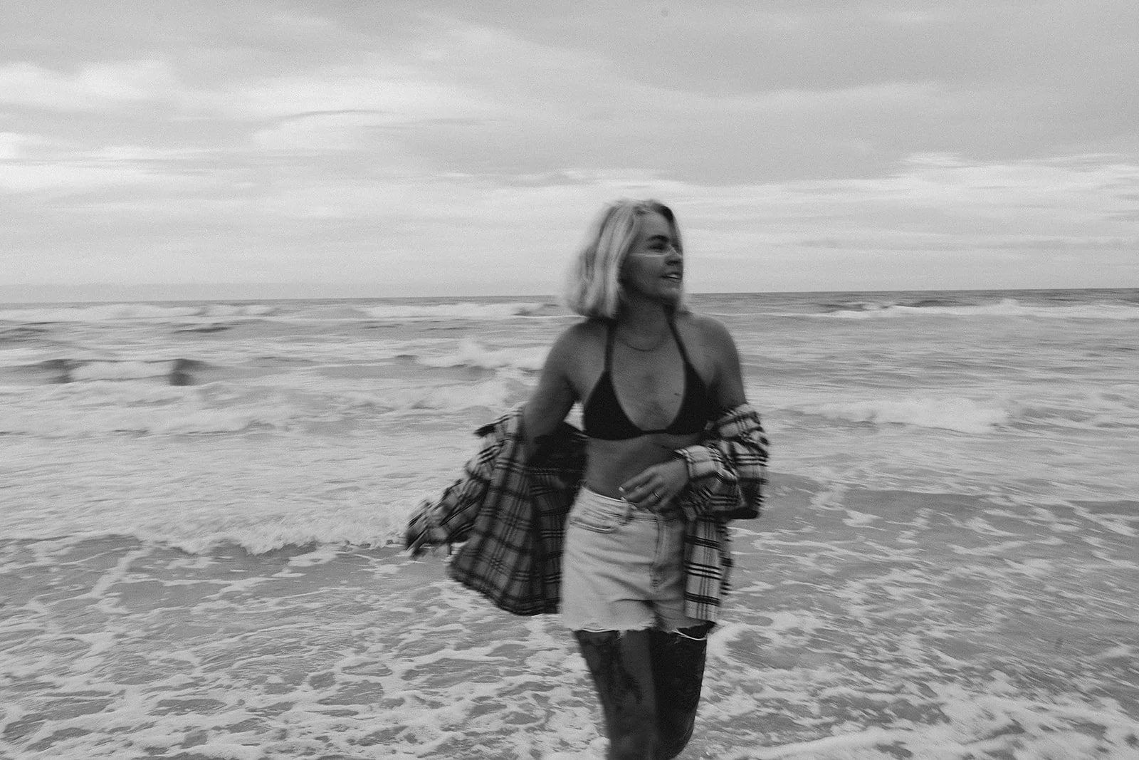 black and white image of girl at beach in water