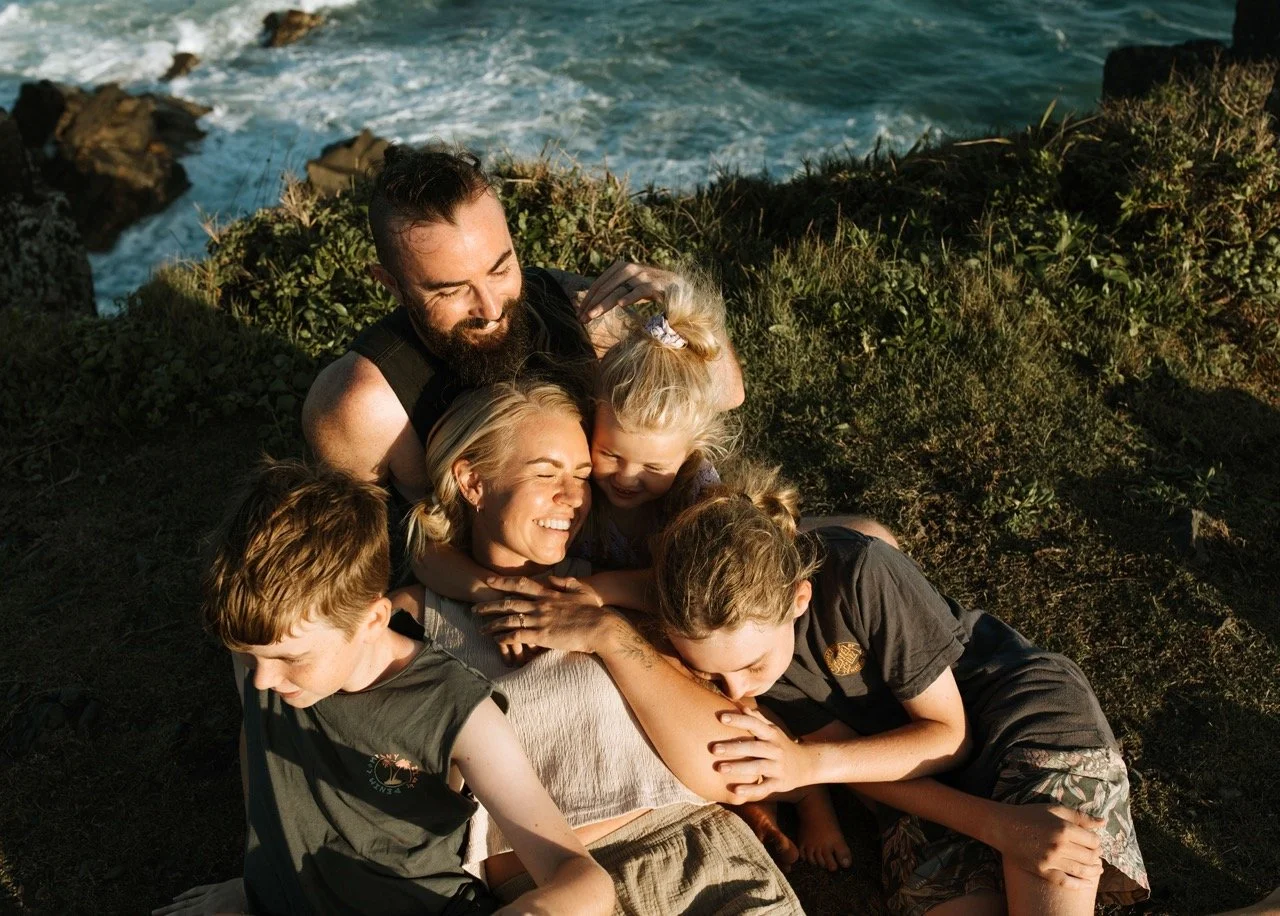 family cuddles at beach