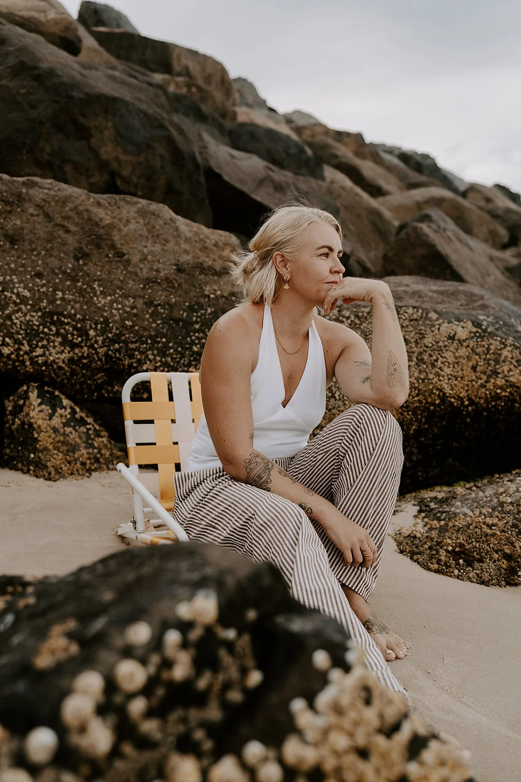 girl sitting on chair at beach