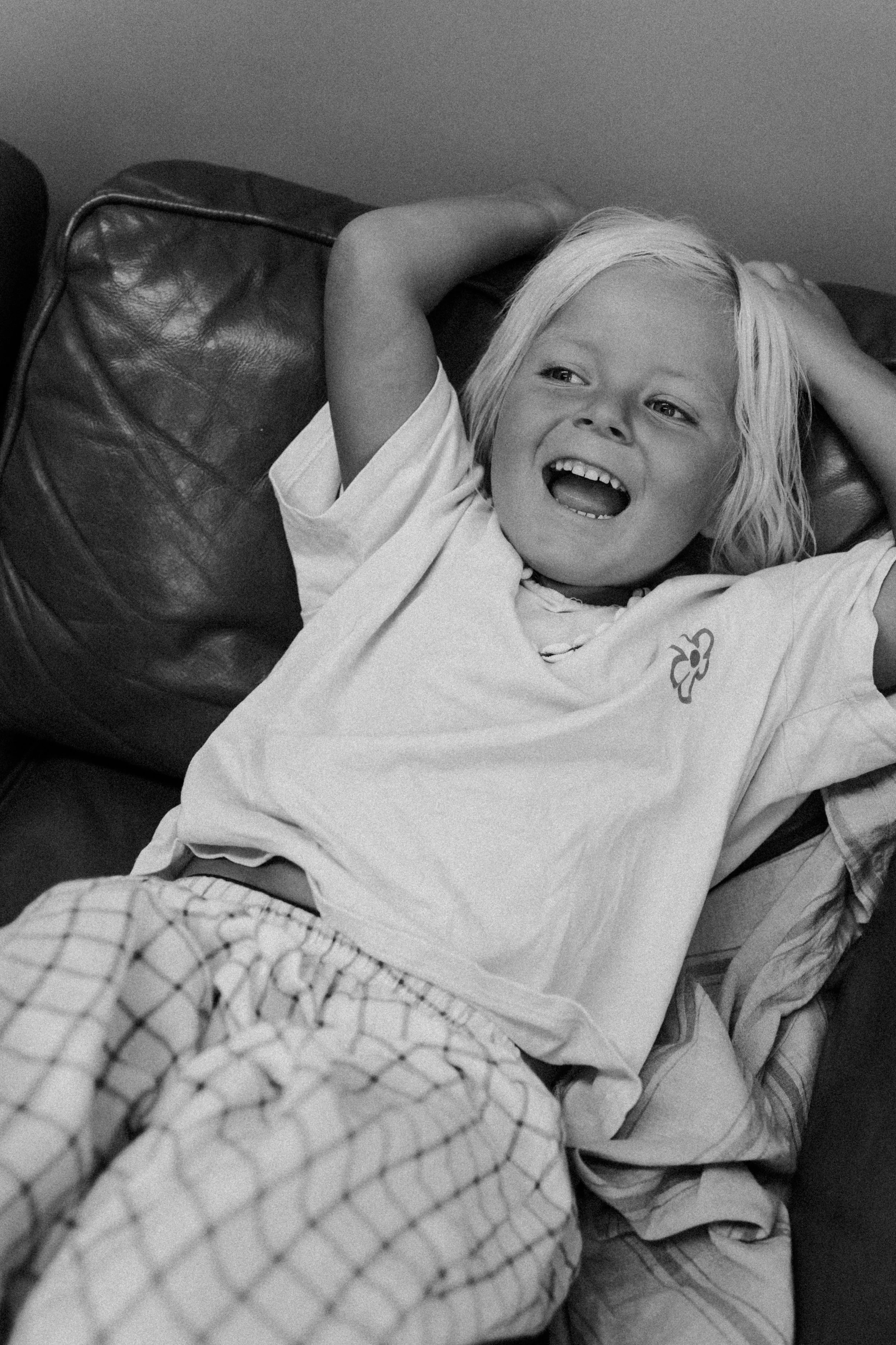 happy boy laughing on lounge