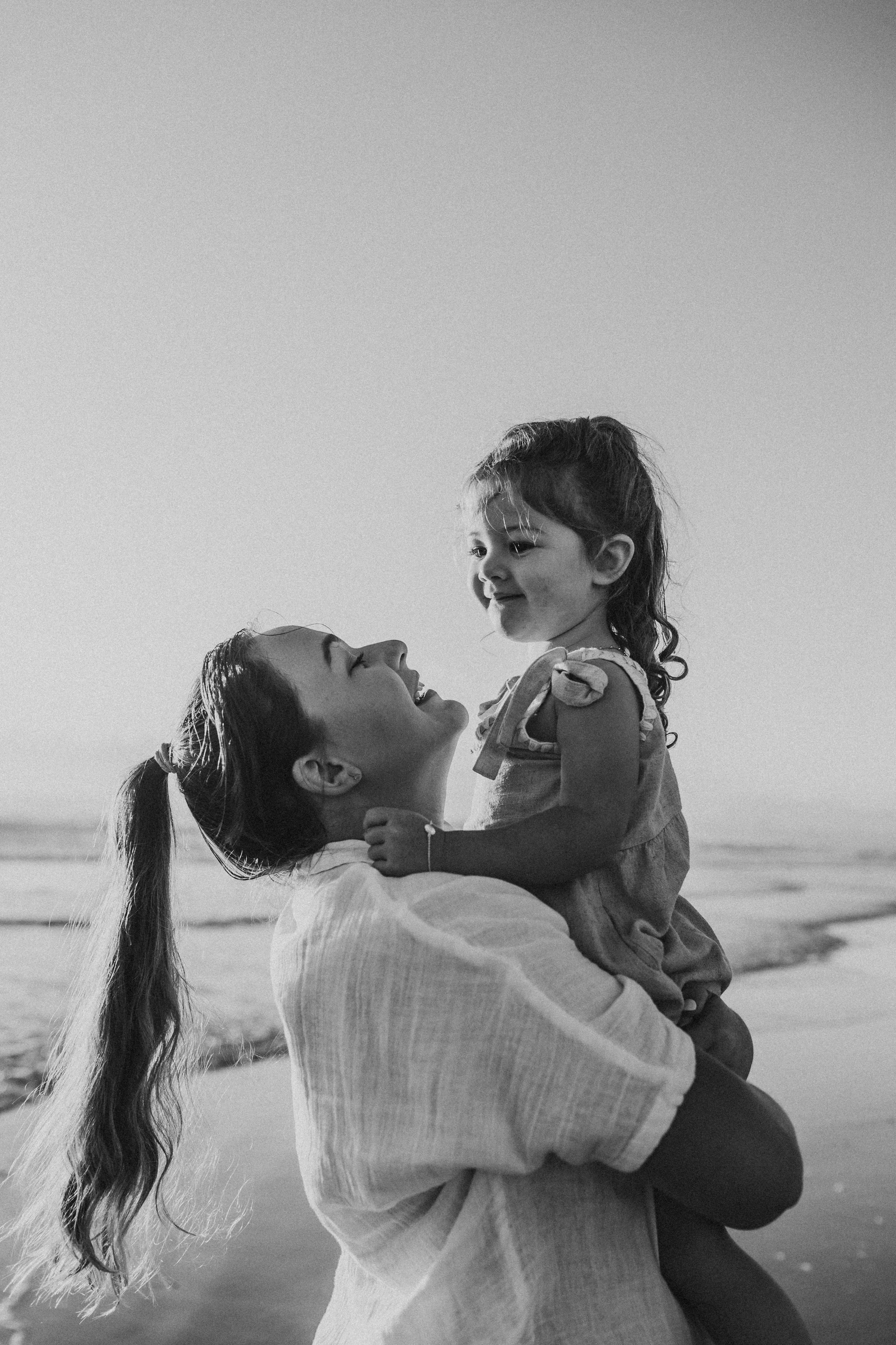 mum and daughter on beach happy photo